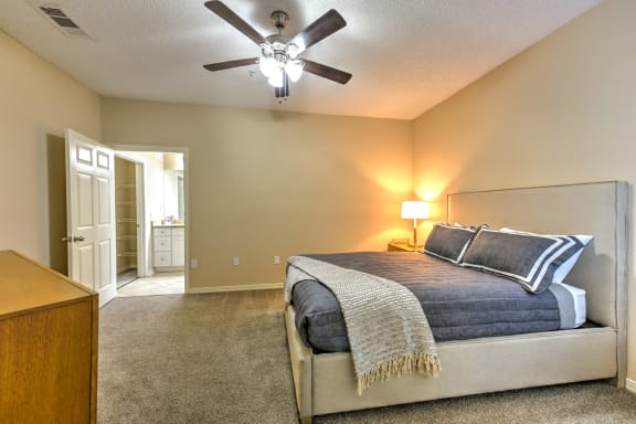 A Bedroom with a Bed and a Ceiling Fan at Ocean Park Apartments in Jacksonville. FL