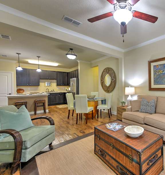 A living room with a couch, chairs, and a coffee table.