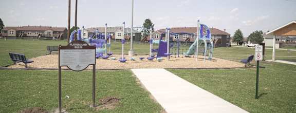 a playground in a park with a sign in front of it  at Antelope Ridge, South Dakota, 57719