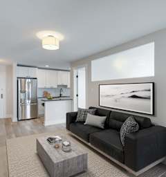 a living room with a couch and a table and a kitchen