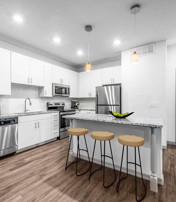 a kitchen and dining room with a glass table and chairs