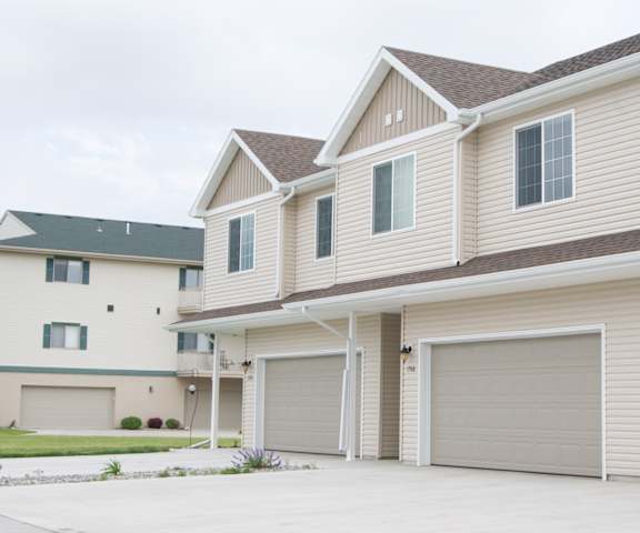A two-story house with a garage on the side.