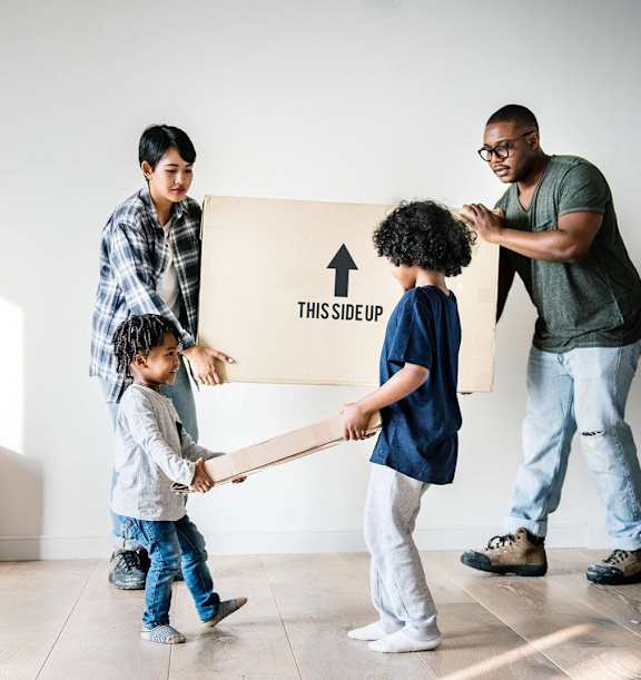 Family moving boxes inside a new home