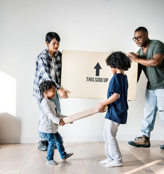 Family moving boxes inside a new home