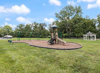 apartment community with a playground and a gazebo