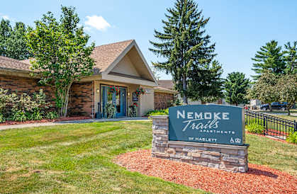 Nemoke Trails of Haslett sign in front of a building.
