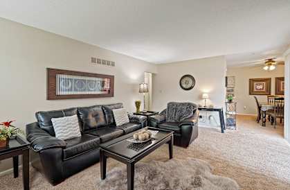 a living room with leather couches and a coffee table
