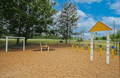 a playground with a swing set and a picnic table