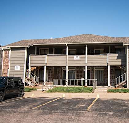 A building with a parking lot in front of it.