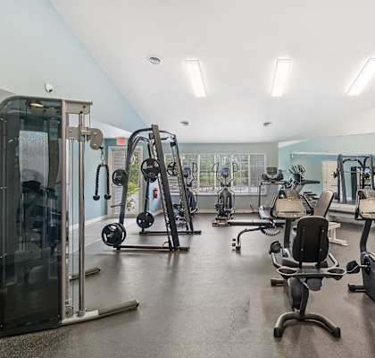 a gym with weights and cardio equipment in a building