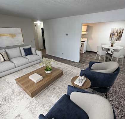 A living room with a grey couch and a coffee table.