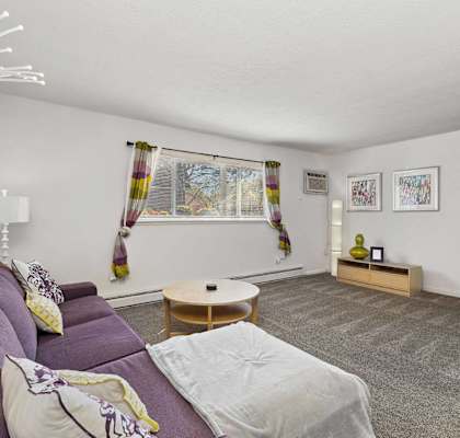 a living room with a purple couch and a table