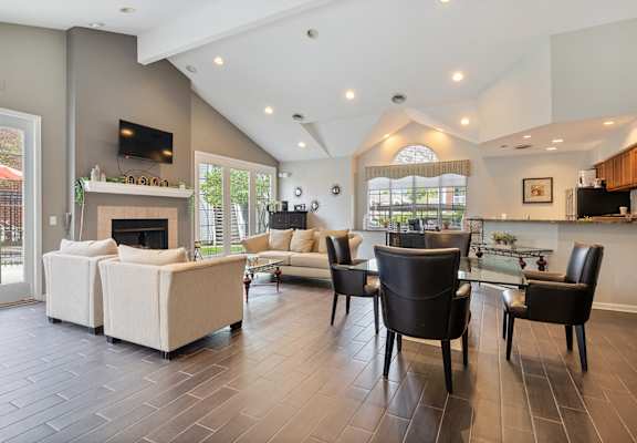 a living room with couches and a table and a fireplace