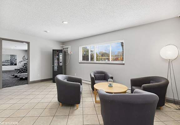 a living room with chairs and a table