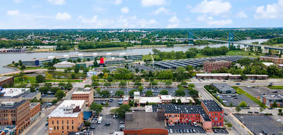 an aerial view of a city with buildings and a river