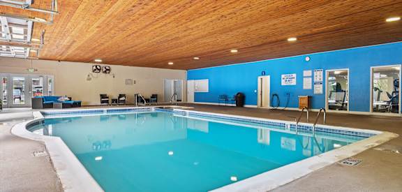 A large indoor swimming pool with a wooden ceiling.