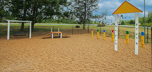 a playground with a swing set and a picnic table