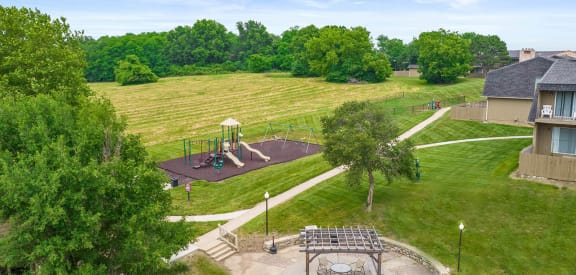 an aerial view of a park with a playground and a large field