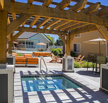 a backyard with a pool and a wooden pergola at Skyview Apartments, Westminster Colorado