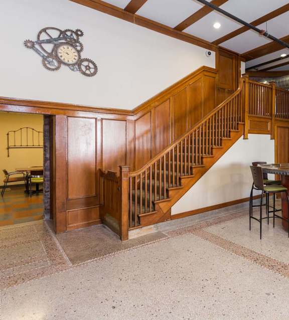 A room with a staircase and a fireplace.at Riverpoint Lofts, Des Moines, 50309