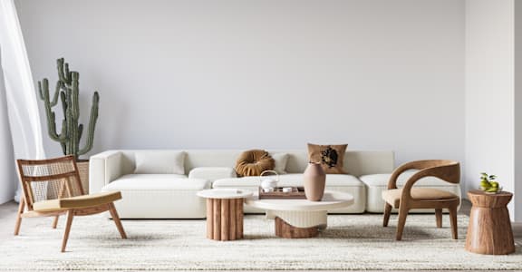 a living room with a white couch and tables