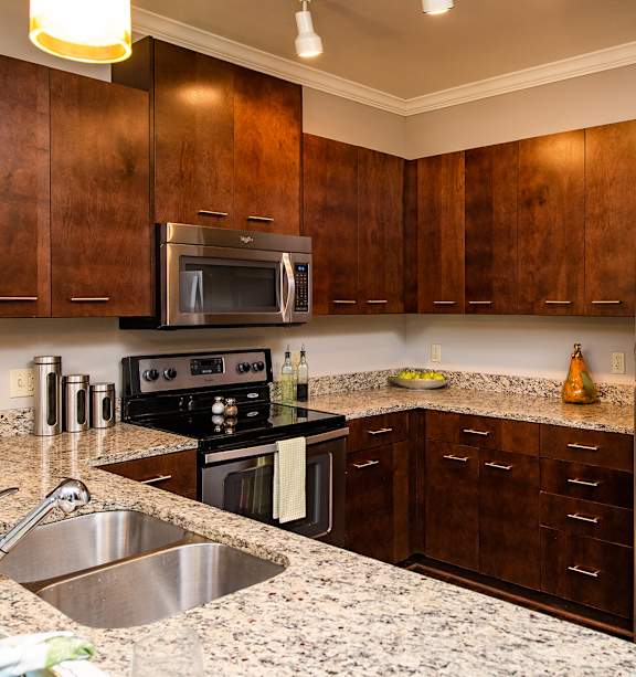 a living room with a couch and a tv at WaterCrest at City Center, Kansas, 66219