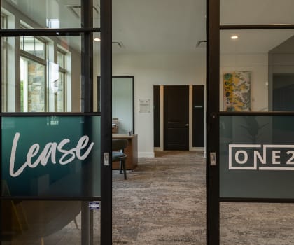a view through the glass doors of the leasing office at The Clearing at ONE28, Olathe