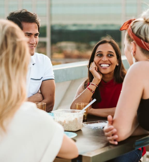 a group of people sitting around a table eating food  at The Grand, Kansas City