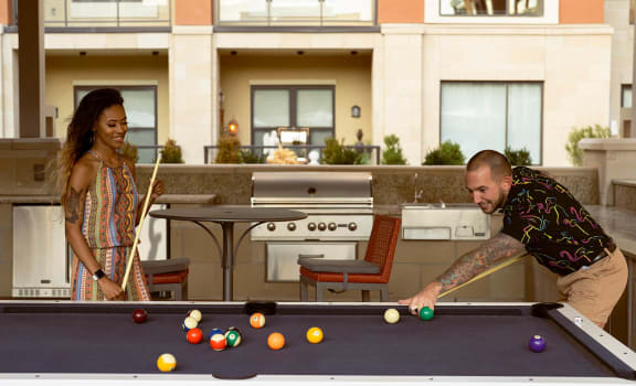 Couple playing pool at The Residences at Galleria, Overland Park, KS, 66211