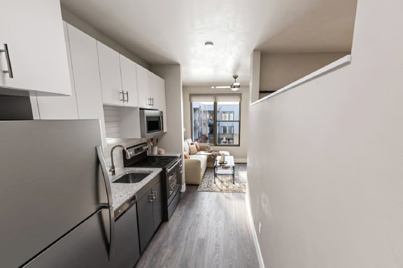 a kitchen with stainless steel appliances and white cabinets