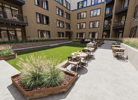a courtyard with tables and chairs in the middle of an apartment building