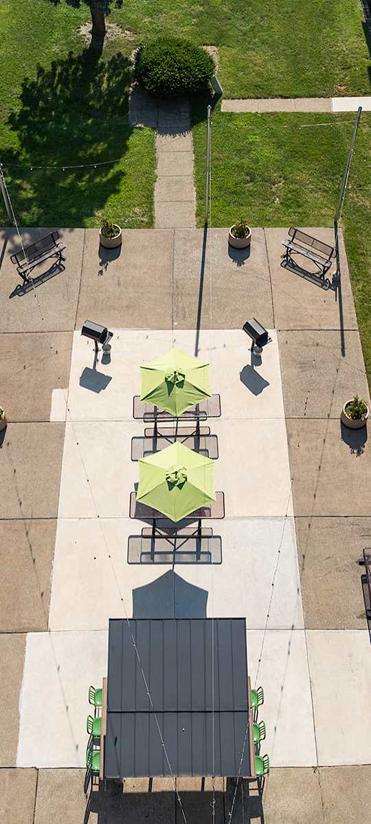 A courtyard surrounded by buildings with tables and chairs.