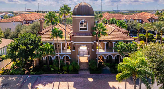 Iconic domed clubhouse surrounded by palm trees and Mediterranean architecture