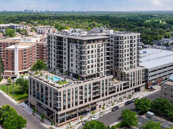 A large multi-story building with a pool on the top floor.
