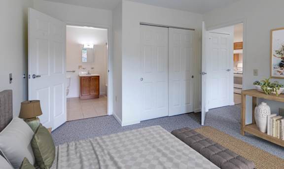 A bedroom with a bed, a nightstand, and a dresser at The Birches at Saugerties Apartments, Saugerties, NY, 12477