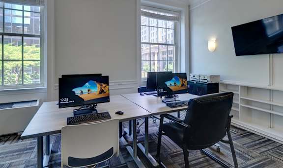 a room with two computers and two chairs