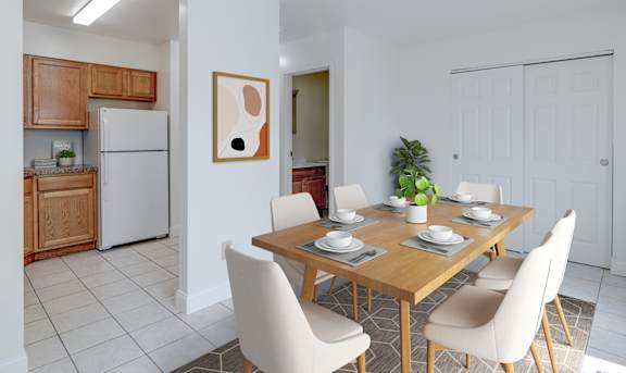 A dining room with a table set for four.