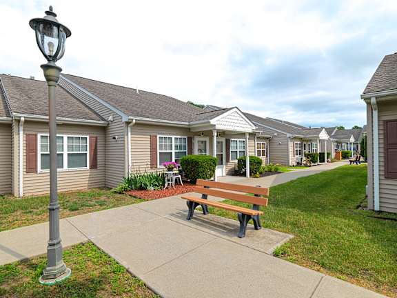 A street lamp stands on a sidewalk in front of a row of houses at The Birches at Saugerties Apartments, Saugerties, NY, 12477