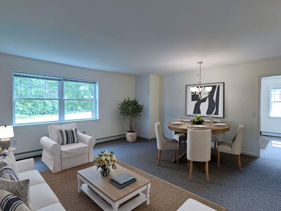 a living room with a table and chairs in the middle of the room