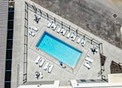 Thumbnail 5 of 7 - An aerial view of a pool surrounded by lounge chairs and umbrellas.