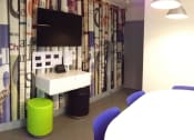 Thumbnail 4 of 8 - a room with a table and chairs and a television