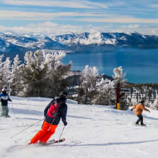 a group of skiers skiing down a snow covered slope