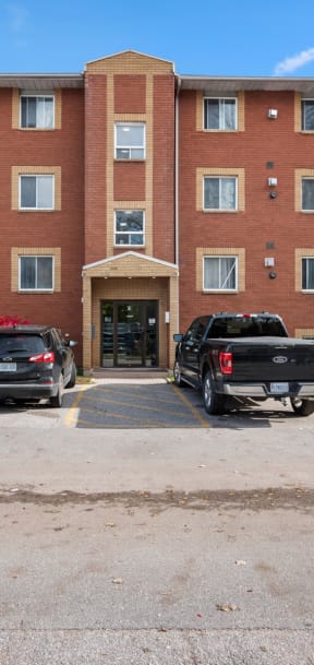 a large brick building with a parking lot in front of it