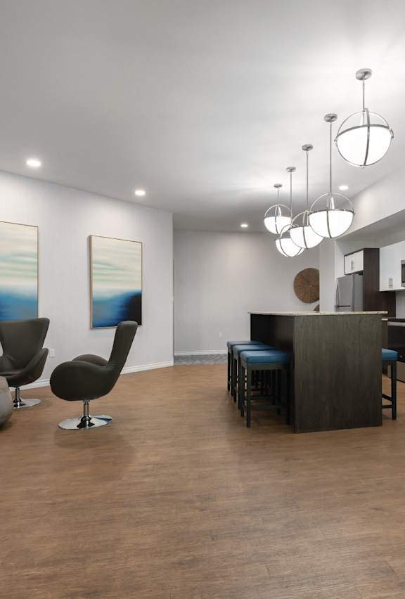 A modern kitchen with dark wood floors and a bar area.