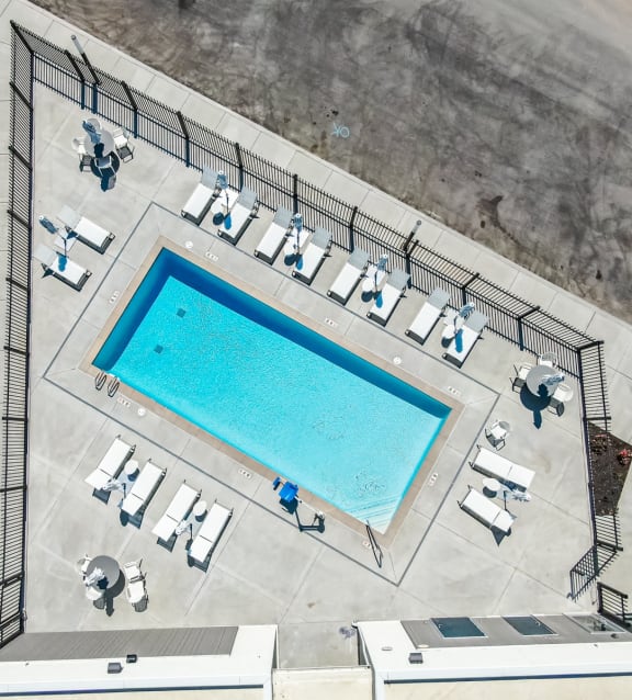 arial view of the pool and lounge area of a building with a swimming pool