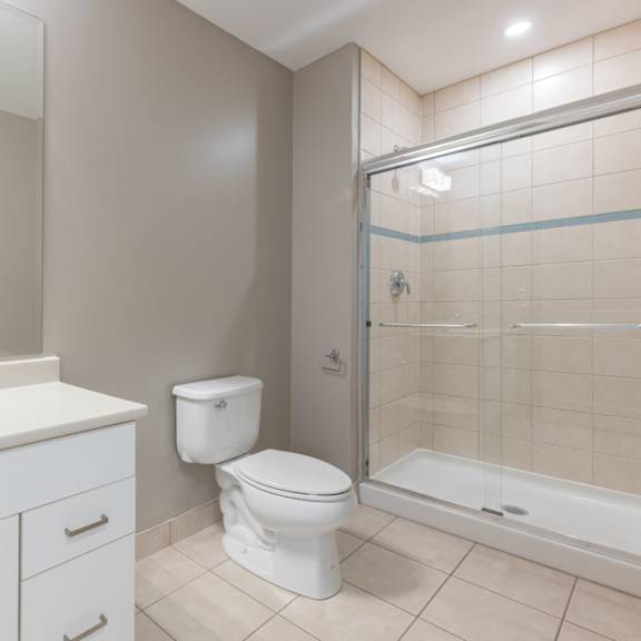 A white toilet sits next to a sink in a bathroom.