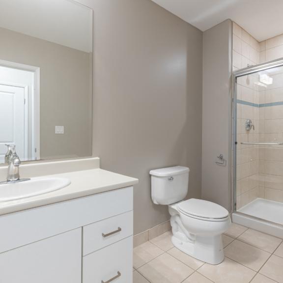 A white toilet sits next to a sink in a bathroom.