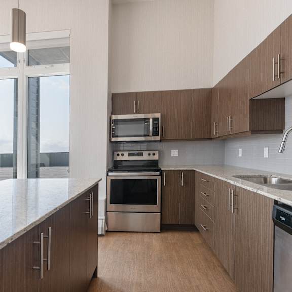 A modern kitchen with wooden cabinets and stainless steel appliances.