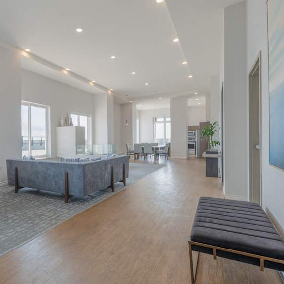 A large, modern room with a long table and chairs.