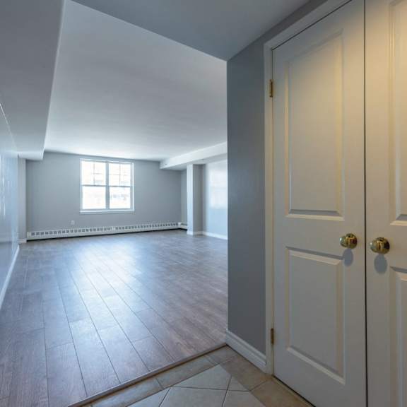 A room with a white door and a window.